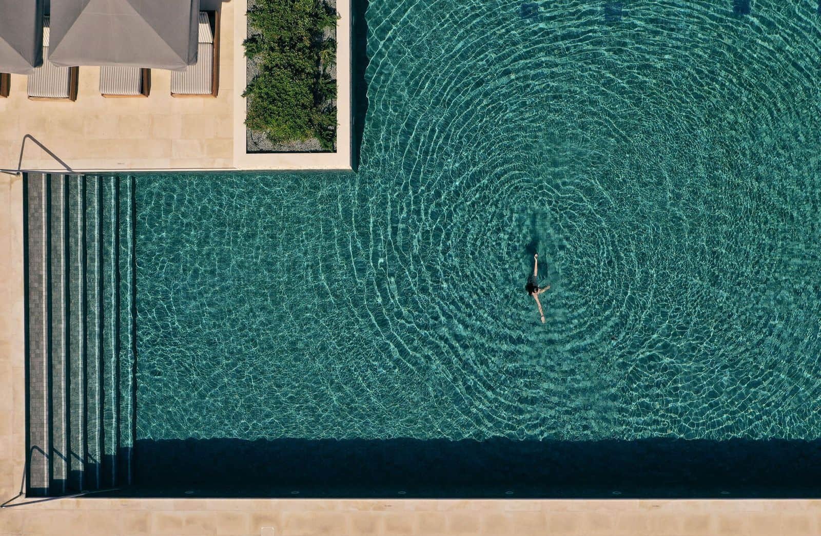 Aerial view of a swimmer in the pool at Cap St Georges Hotel and Resort